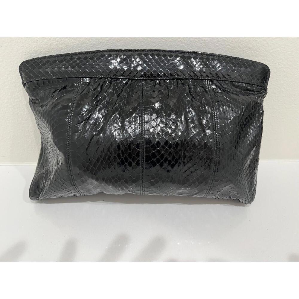 Black leather clutch handbag, strap, textured medium